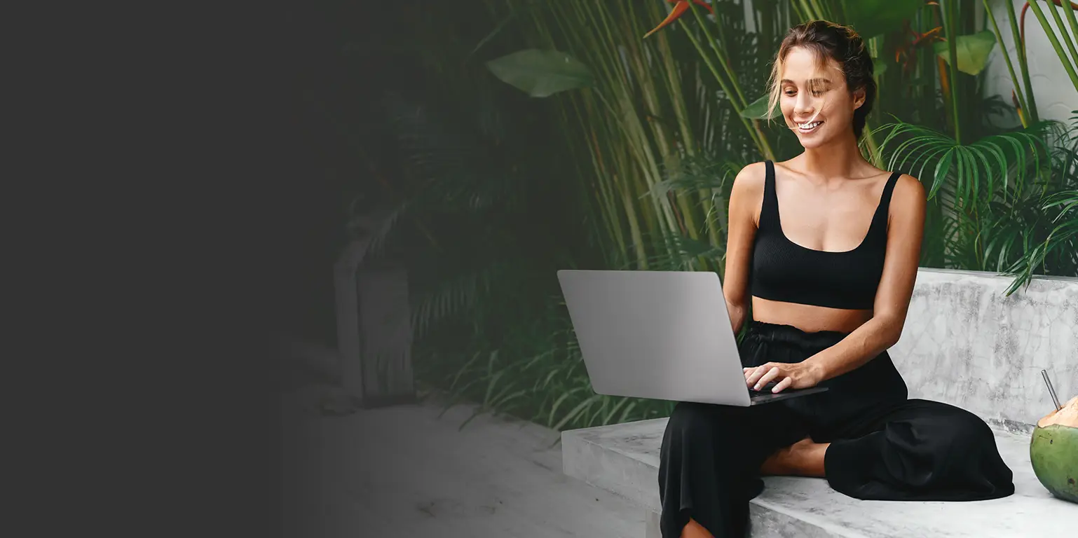 Woman in fitness clothing sitting with her laptop