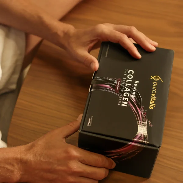 Box of the Rewind Liquid collagen, man holding the box ready to open.
