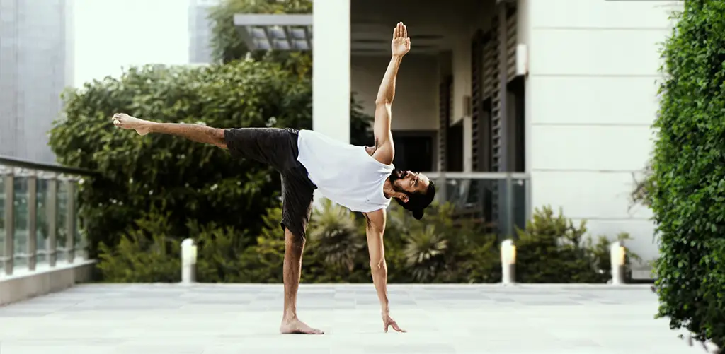 man is doing yoga outside looking to the sky
