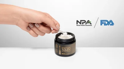 A hand holding a bottle of NMN supplements, symbolizing FDA approval and renewed access to NMN as a dietary supplement in 2025.