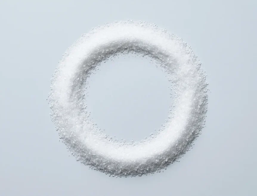 Close-up photograph of pure aspartame powder presented as a fine, white crystalline substance on a neutral background, highlighting its sugar-like texture and raw form as discussed in the blog post on non-sugar artificial sweeteners and health.
