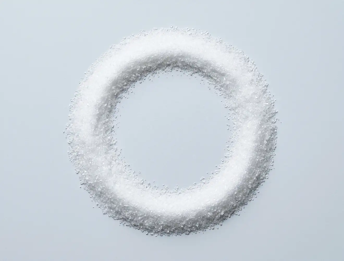 Close-up photograph of pure aspartame powder presented as a fine, white crystalline substance on a neutral background, highlighting its sugar-like texture and raw form as discussed in the blog post on non-sugar artificial sweeteners and health.