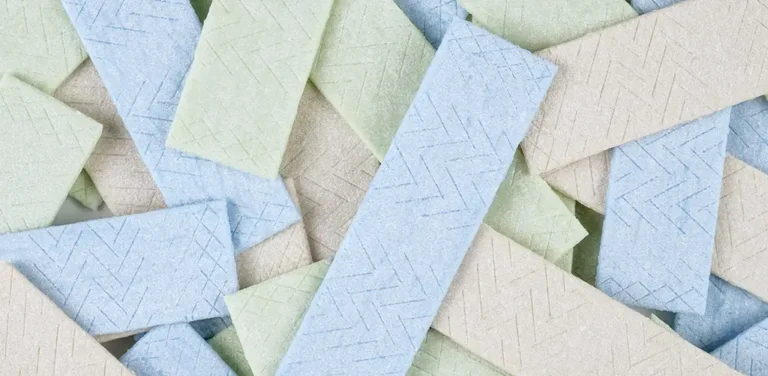 Pastel-colored pieces of sugar-free chewing gum stacked together, commonly sweetened with artificial sweeteners such as aspartame.