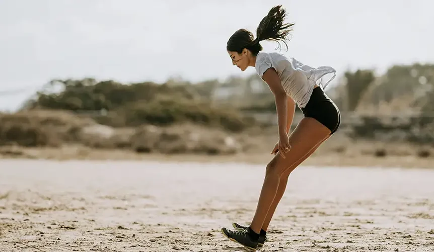 Woman exercising outdoors in warm sunlight, illustrating energy, physical performance, and healthy aging supported by mitochondrial health and CoQ10.