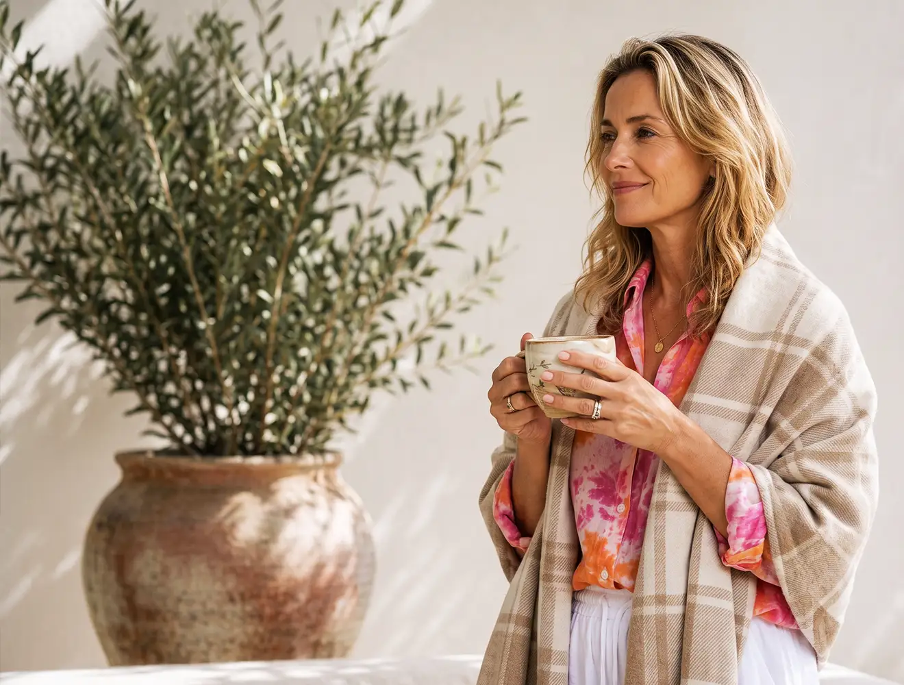 woman with a cup of tea in her garden